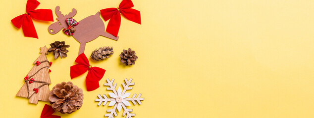 Christmas yellow background with holiday toys and decorations. Banner Happy New Year concept with empty space for your design