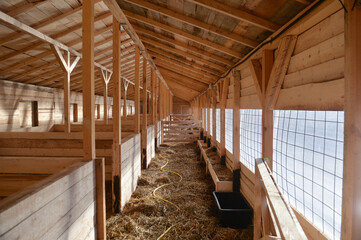 Empty woden stable/ barn with hay  on the floor © black