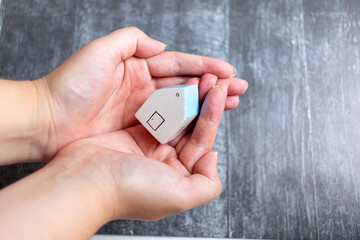 house in hand. Family house and shelter for homeless. Stay at home