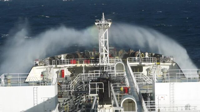 Close up view of ship forward part during storm in the ocean. Sea wave cick against bow of the vessel.