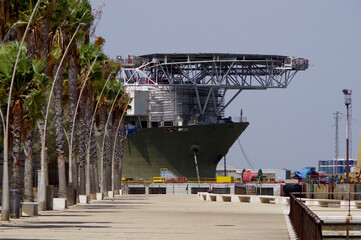 A huge pipe layer in the port of Cad&iacute;z, at the end of an avenue of palm trees.
