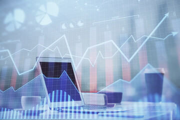 Stock market graph and table with computer background. Double exposure. Concept of financial analysis.