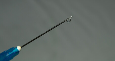 a thin stream of medicine from a medical syringe.