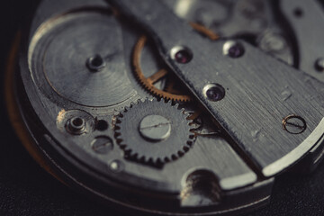Old clockwork dirty with dust and lubricating oil. Selective focus. Shallow depth of field. Toned