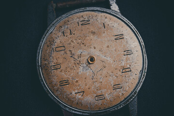 Old dial of a vintage watch. Worn and scratched surface