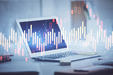 Forex graph hologram on table with computer background. Multi exposure. Concept of financial markets.