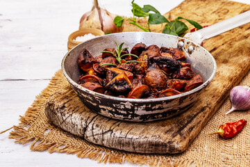 Ready to eat hot fried brown champignons in vintage pan
