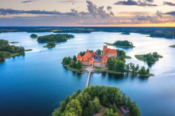 Summer landscape. Aerial view of Trakai castle. Historical sightseeings of Lithuania. Early sunrise. Green islands among of lake. Blue water in lake. 