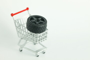 Miniature shopping cart model containing wheel of model car scene represent car part online...