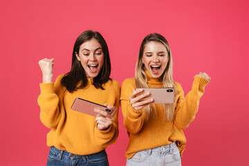 Two happy pretty girls celebrating success