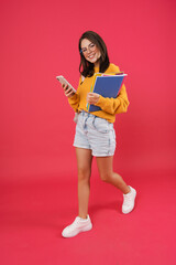 Happy young smiling woman walking with cellphone