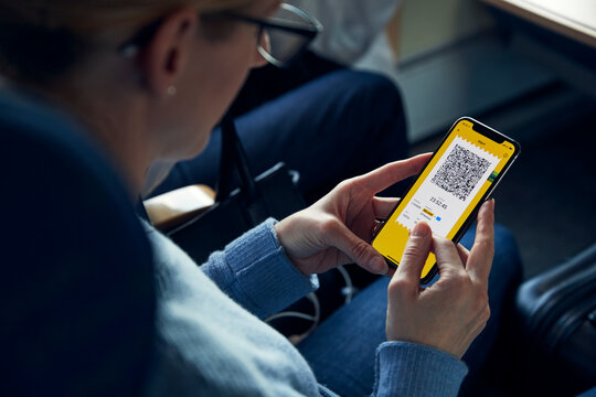 Woman holding cell phone with e-ticket