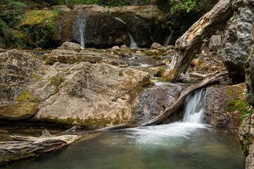 Naklejka na ściany i meble Mountain stream, mountain waterfall, waterfall in the forest, rocky river