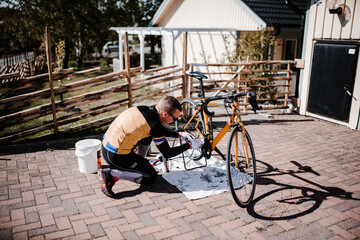 Man repairing bicycle - 383838474