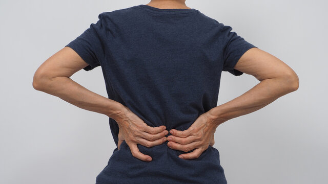 Asian Senior Or Older Woman Had A Back Pain Posture On White Background.