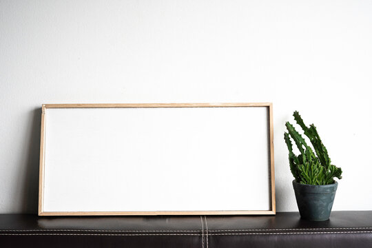 Blank picture frame and cactus tree, copy space for text.