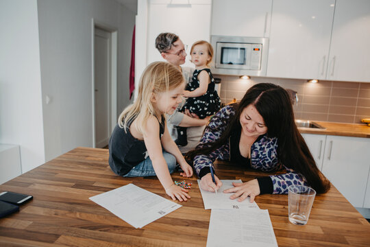Women with two daughters in kitchen