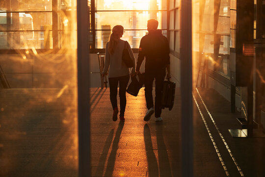 Silhouette of couple walking through corridor