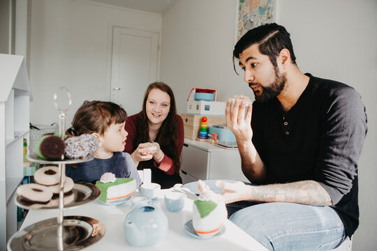 Girl having tea party with parents