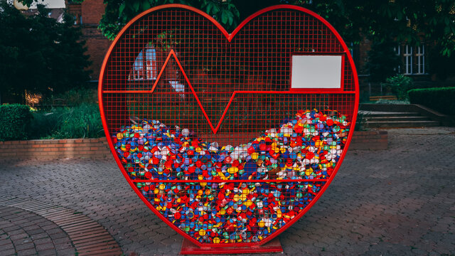 Cap collecting. An ecological container for plastic caps shaped in hearth with a lifeline.