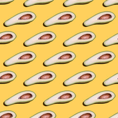 Seamless pattern with avocado on yellow background.
