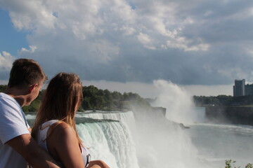 Lovers are looking at waterfall view - Niagara, USA - Canada.