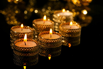 Indian festival diwali , candle on dark background