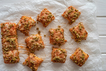 Homemade square pizza with tomato sauce, cheese and chopped olives.