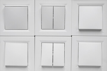 Many light switch, a plastic mechanical switch of white color.