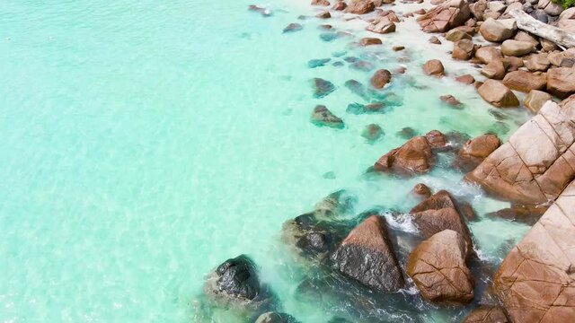 Aerial top down view footage of clear turquoise blue ocean water of Redang Island in Terengganu Malaysia