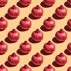 Seamless pattern with pomegranate on yellow background.