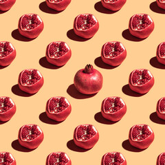 Seamless pattern with pomegranate fruits for Jewish holiday Rosh Hashanah on yellow background.