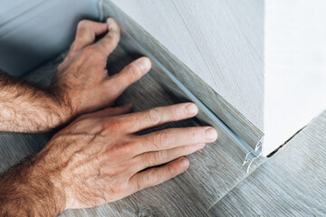 How to install a plastic skirting board on a floor with a cable channel - installing a decorative cover