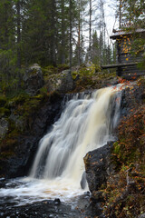 A small waterfall in Ukkohalla, Kainuu Finland. Autumn colors and streaming cool, clear water