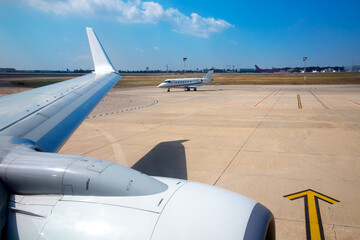 Airplane wing in airport with aircraft background