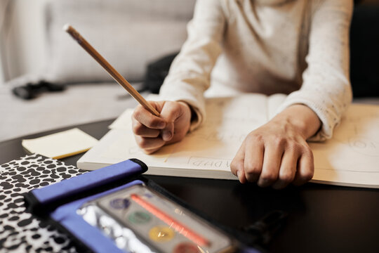 High angle view of electronic ADHD aid, child writing on background