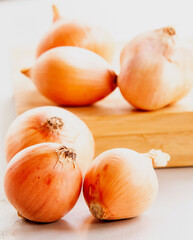 bunch of golden onions close up on white