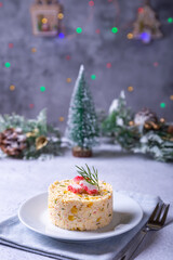 Crab salad with corn and eggs on a white plate. New Year's and Christmas. Traditional Russian salad. Close-up.