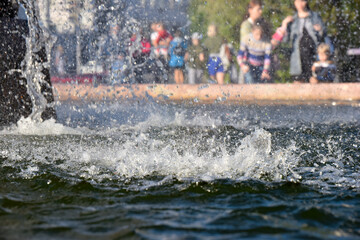selective focus at the splashes of water at the city park