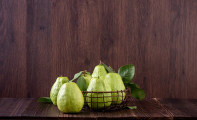 Close up of delicious guava with fresh green leaves.