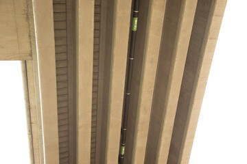 Up view of the beneath concrete bridge and long black pipe with label "RL" with direction for rain line to drain the water from the road way out. It is the normal view from the car in the urban city