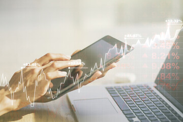 Multi exposure of abstract financial graph and hand working with a digital tablet on background,...