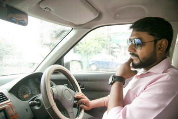 an Indian man driving a car