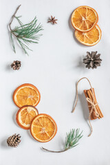 Fototapeta na wymiar Dried orange, anise, pine cone, cinnamon and pine branches on a white background
