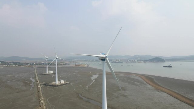 Three large windmills in Tando port, front view