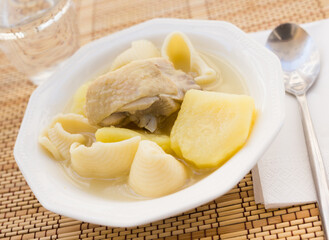 chicken broth soup with chicken, potatoes, and pasta shells