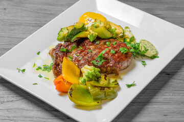 beef and roasted vegetables on a plate