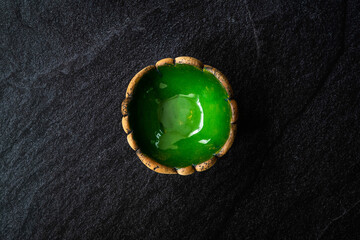 Handmade Ceramic Pottery Cup / Handcrafted Bowl on Dark Surface and Background.