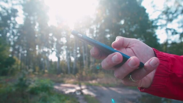 Checking an important message on your phone. The hand holds the phone, presses the screen, shakes, nervous experience when receiving information.