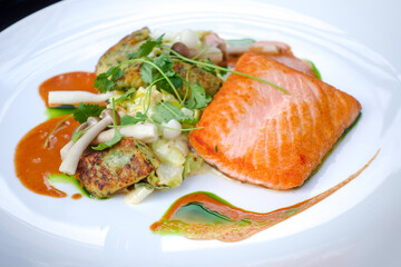 Grilled salmon and lemon - french cuisine dish with tomato and salmon